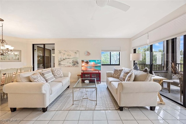 6500 Valen Way Unit A402, Naples, FL 34108 - living room featuring light tile patterned flooring and a chandelier
