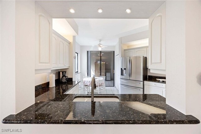 6500 Valen Way Unit A402, Naples, FL 34108 - kitchen with stainless steel refrigerator with ice dispenser, a sink, a ceiling fan, dark stone countertops, and a peninsula