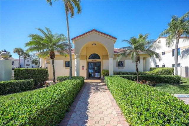 6500 Valen Way Unit A402, Naples, FL 34108 - doorway to property featuring french doors and stucco siding