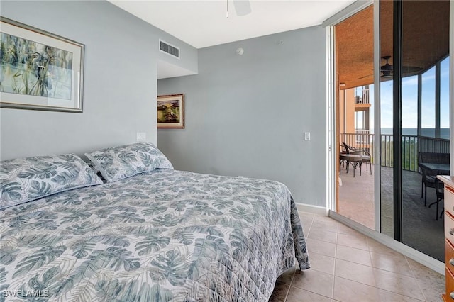 3191 Matecumbe Key Rd Unit 607, Punta Gorda, FL 33955 - bedroom with access to exterior, a wall of windows, light tile patterned floors, and ceiling fan