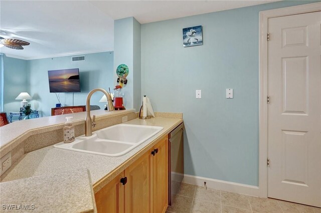 3191 Matecumbe Key Rd Unit 607, Punta Gorda, FL 33955 - kitchen with stainless steel dishwasher, light countertops, light tile patterned flooring, and brown cabinets
