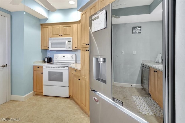 3191 Matecumbe Key Rd Unit 607, Punta Gorda, FL 33955 - kitchen with white appliances, light tile patterned floors, light countertops, and light brown cabinets
