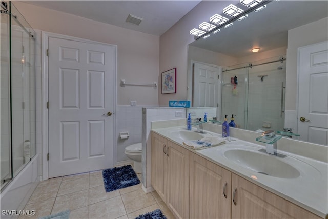 14561 Glen Cove Dr Unit 904, Fort Myers, FL 33919 - full bathroom featuring tile patterned floors, toilet, double vanity, and bath / shower combo with glass door