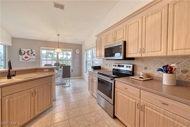 14561 Glen Cove Dr Unit 904, Fort Myers, FL 33919 - kitchen featuring stainless steel appliances, light brown cabinets, a sink, and decorative backsplash