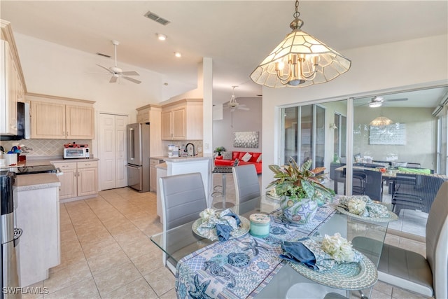 14561 Glen Cove Dr Unit 904, Fort Myers, FL 33919 - dining area with ceiling fan, light tile patterned flooring, a chandelier, and vaulted ceiling