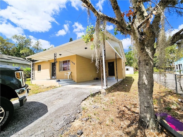 1112 Evanston St, Sebring, FL 33870 - view of front of home with asphalt driveway and an attached carport