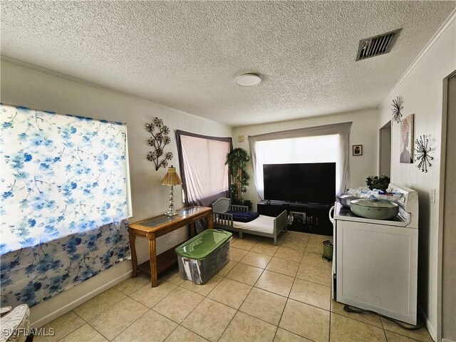 1112 Evanston St, Sebring, FL 33870 - living room with light tile patterned floors and a textured ceiling
