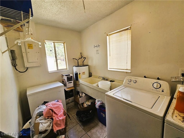 1112 Evanston St, Sebring, FL 33870 - laundry area featuring washing machine and dryer, electric water heater, electric panel, a textured ceiling, and tile patterned flooring