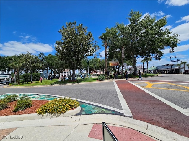1112 Evanston St, Sebring, FL 33870 - view of asphalt road with street lights, curbs, and sidewalks