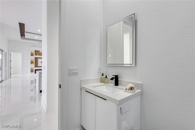 149 SE 21st St, Cape Coral, FL 33990 - bathroom featuring a textured wall, vanity, and recessed lighting