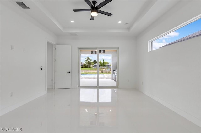 149 SE 21st St, Cape Coral, FL 33990 - spare room with plenty of natural light, tile patterned flooring, a raised ceiling, ceiling fan, and recessed lighting