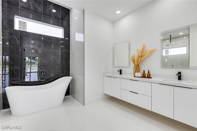 149 SE 21st St, Cape Coral, FL 33990 - full bathroom featuring double vanity, a freestanding bath, healthy amount of natural light, and recessed lighting