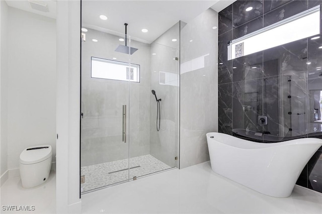 149 SE 21st St, Cape Coral, FL 33990 - bathroom featuring a shower stall, a freestanding tub, healthy amount of natural light, and recessed lighting