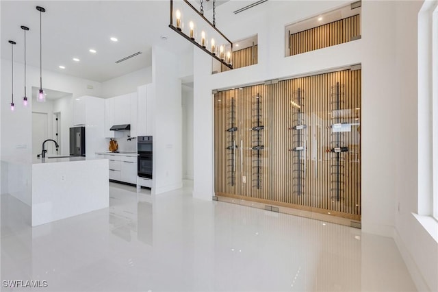 149 SE 21st St, Cape Coral, FL 33990 - interior space with a sink, a towering ceiling, light tile patterned flooring, and recessed lighting