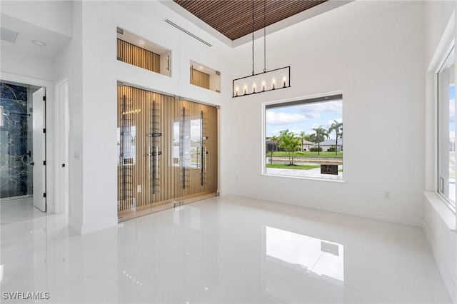 149 SE 21st St, Cape Coral, FL 33990 - tiled empty room with plenty of natural light and a chandelier