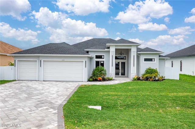 149 SE 21st St, Cape Coral, FL 33990 - prairie-style home featuring a garage, decorative driveway, stucco siding, and a front yard