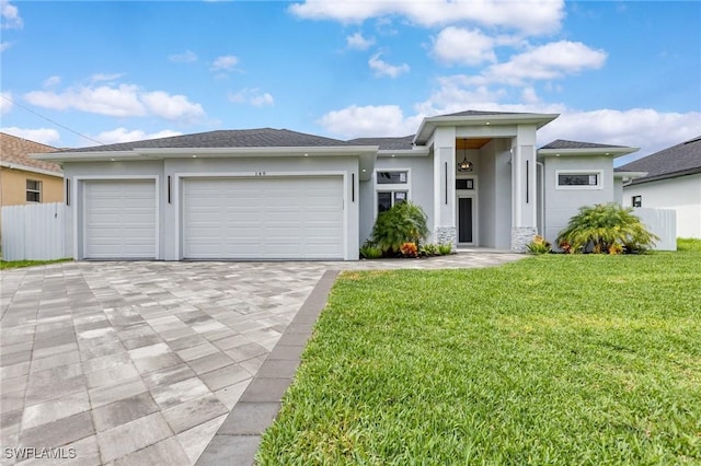 149 SE 21st St, Cape Coral, FL 33990 - prairie-style house featuring stucco siding, decorative driveway, and a garage