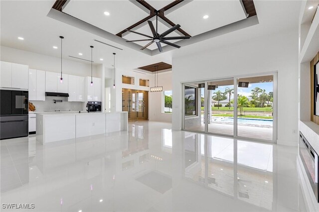149 SE 21st St, Cape Coral, FL 33990 - unfurnished living room with light tile patterned floors, recessed lighting, and a high ceiling