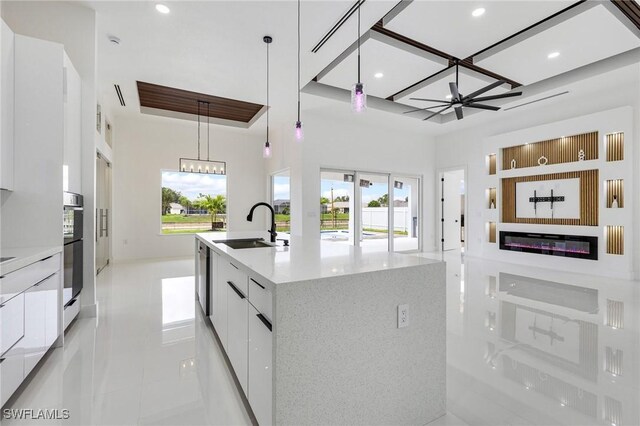 149 SE 21st St, Cape Coral, FL 33990 - kitchen with modern cabinets, a chandelier, a sink, light tile patterned floors, and white cabinetry