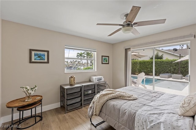 1020 SW 56th St, Cape Coral, FL 33914 - bedroom featuring access to outside, baseboards, light wood-style flooring, and ceiling fan