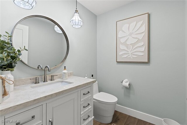 1020 SW 56th St, Cape Coral, FL 33914 - half bathroom featuring toilet, wood finished floors, vanity, and baseboards