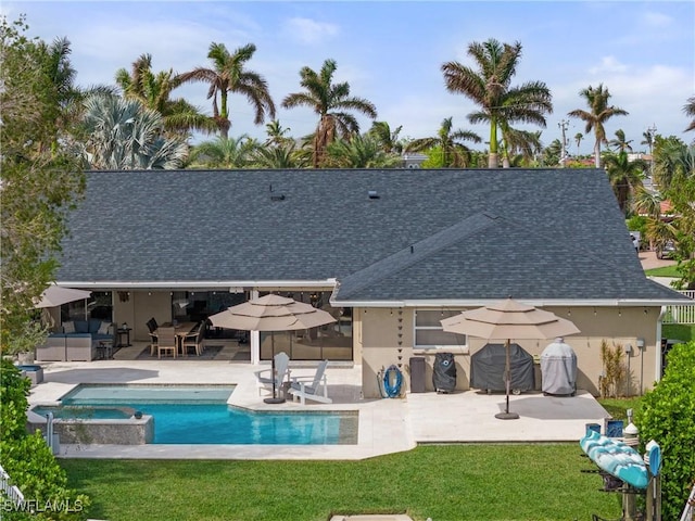 1020 SW 56th St, Cape Coral, FL 33914 - view of pool featuring a patio, a lawn, and a pool with connected hot tub