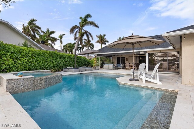 1020 SW 56th St, Cape Coral, FL 33914 - view of swimming pool with an in-ground hot tub, an outdoor hangout area, and a patio area