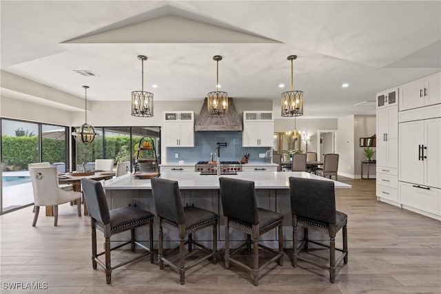 1020 SW 56th St, Cape Coral, FL 33914 - kitchen with a chandelier, backsplash, light countertops, custom range hood, and recessed lighting