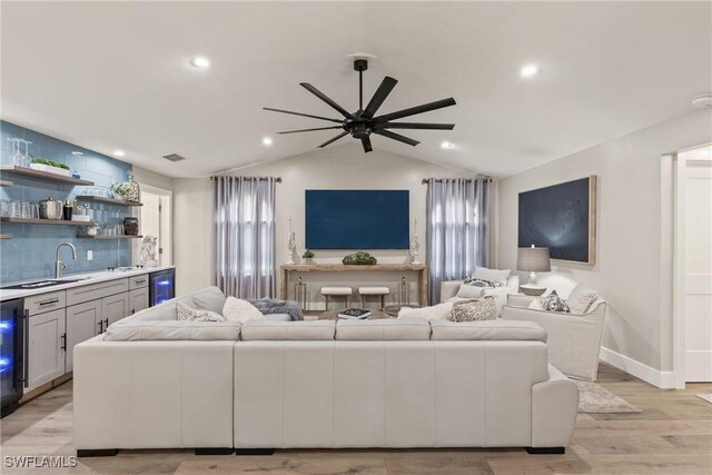 1020 SW 56th St, Cape Coral, FL 33914 - living area with ceiling fan, lofted ceiling, wet bar, light wood-style floors, and wine cooler