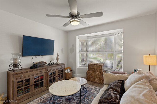 1020 SW 56th St, Cape Coral, FL 33914 - living room featuring ceiling fan, baseboards, and wood finished floors