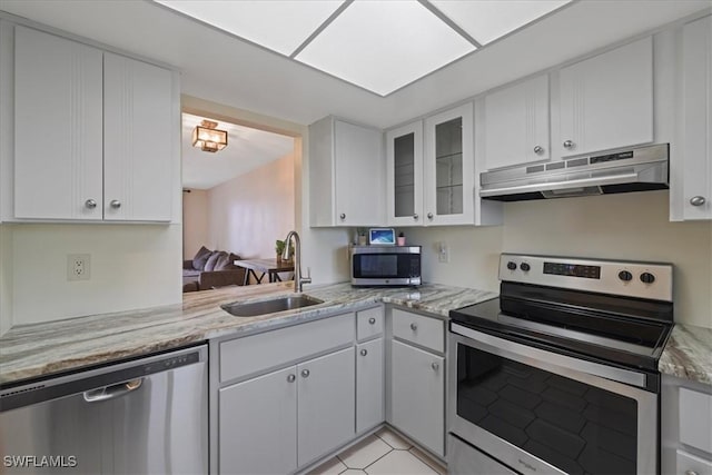 503 Cape Coral Pkwy W Unit 201, Cape Coral, FL 33914 - kitchen featuring under cabinet range hood, stainless steel appliances, a sink, and white cabinets