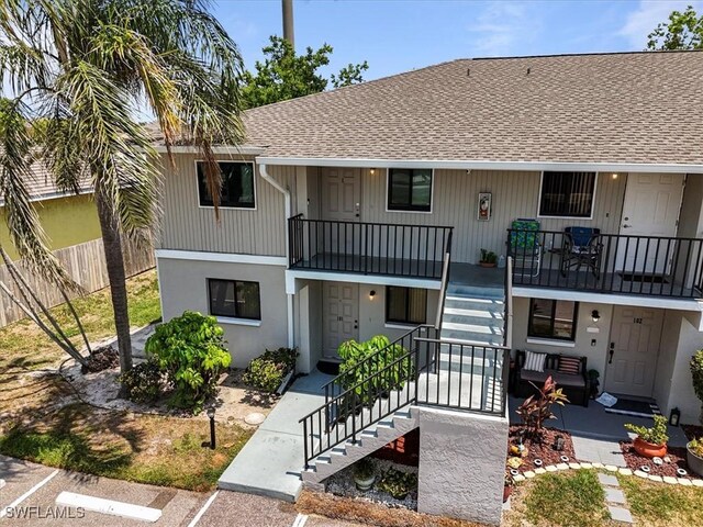 503 Cape Coral Pkwy W Unit 201, Cape Coral, FL 33914 - view of front of house featuring stairway, roof with shingles, and a porch