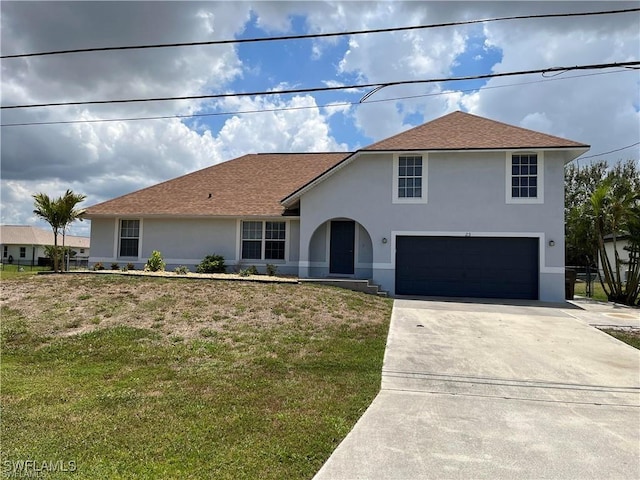 23 NW 22nd Ave, Cape Coral, FL 33993 - view of front of house with stucco siding, concrete driveway, an attached garage, and a front yard