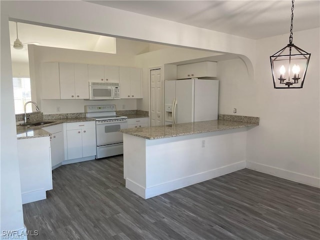 23 NW 22nd Ave, Cape Coral, FL 33993 - kitchen featuring white appliances, a peninsula, a sink, and dark wood-style floors