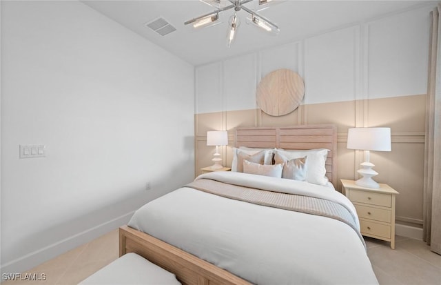 6470 Memorial Ln, Ave Maria, FL 34142 - bedroom featuring light tile patterned floors and a decorative wall