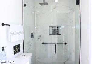 5750 N Andrews Ave, Oakland Park, FL 33309 - full bathroom featuring a marble finish shower and toilet
