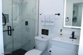 5750 N Andrews Ave, Oakland Park, FL 33309 - full bathroom featuring vanity, toilet, and a marble finish shower