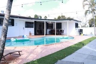 5750 N Andrews Ave, Oakland Park, FL 33309 - back of house featuring a patio and an outdoor pool