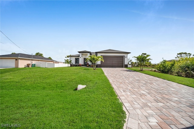 1925 NW 30th Ter, Cape Coral, FL 33993 - prairie-style home with decorative driveway, an attached garage, a front yard, and stucco siding