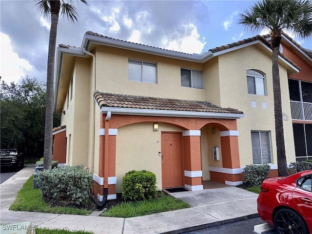 6401 Aragon Way Unit 102, Fort Myers, FL 33966 - townhome / multi-family property with a tile roof and stucco siding