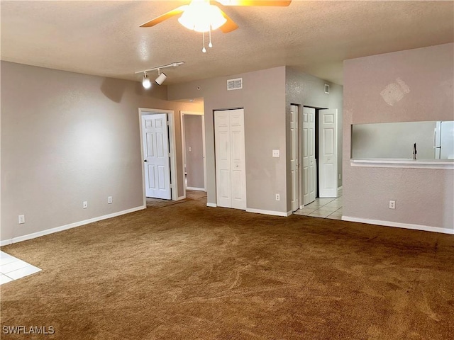 6401 Aragon Way Unit 102, Fort Myers, FL 33966 - carpeted spare room featuring a ceiling fan, a textured ceiling, and baseboards