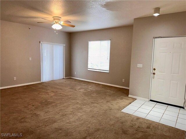 6401 Aragon Way Unit 102, Fort Myers, FL 33966 - carpeted entrance foyer with a ceiling fan, a textured ceiling, and baseboards