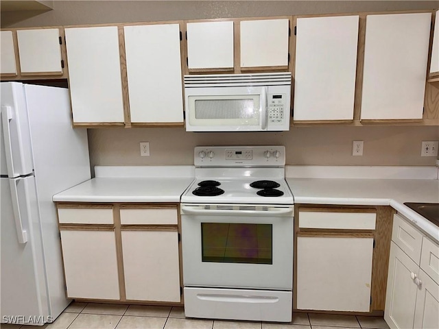 6401 Aragon Way Unit 102, Fort Myers, FL 33966 - kitchen featuring white appliances, light countertops, light tile patterned floors, white cabinets, and a sink