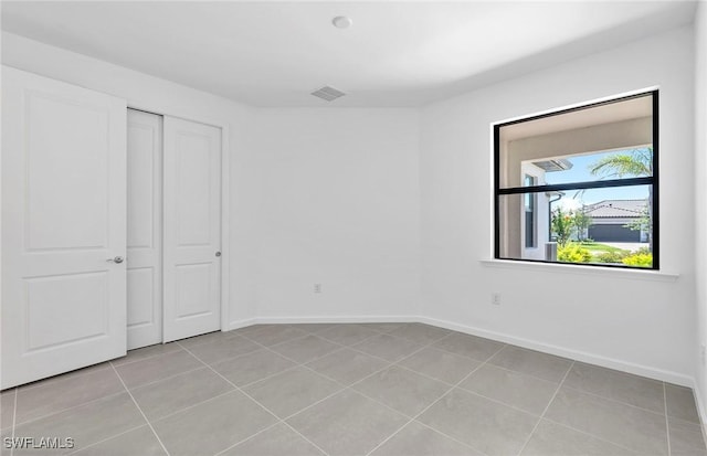 6459 Memorial Ln, Ave Maria, FL 34142 - unfurnished bedroom with light tile patterned floors, baseboards, and a closet