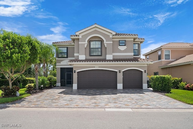11651 Oakwood Preserve Pl, Fort Myers, FL 33913 - mediterranean / spanish-style home with a tiled roof, a garage, stucco siding, and decorative driveway