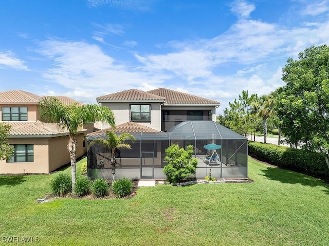 11651 Oakwood Preserve Pl, Fort Myers, FL 33913 - rear view of property with a lawn, glass enclosure, a tile roof, and stucco siding