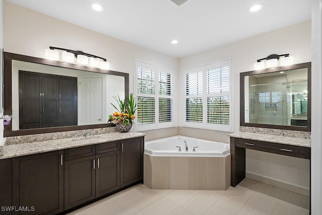 11651 Oakwood Preserve Pl, Fort Myers, FL 33913 - bathroom with a stall shower, two vanities, a bath, recessed lighting, and tile patterned floors