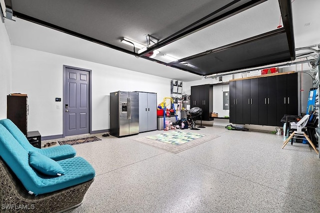 11651 Oakwood Preserve Pl, Fort Myers, FL 33913 - garage featuring stainless steel fridge with ice dispenser and baseboards