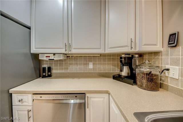 7116 Blanquilla Ct Unit 220, Fort Myers, FL 33908 - kitchen with stainless steel dishwasher, white cabinetry, decorative backsplash, and light countertops