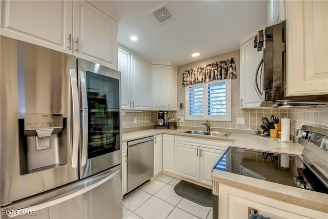 7116 Blanquilla Ct Unit 220, Fort Myers, FL 33908 - kitchen with appliances with stainless steel finishes, a sink, light countertops, tasteful backsplash, and light tile patterned floors